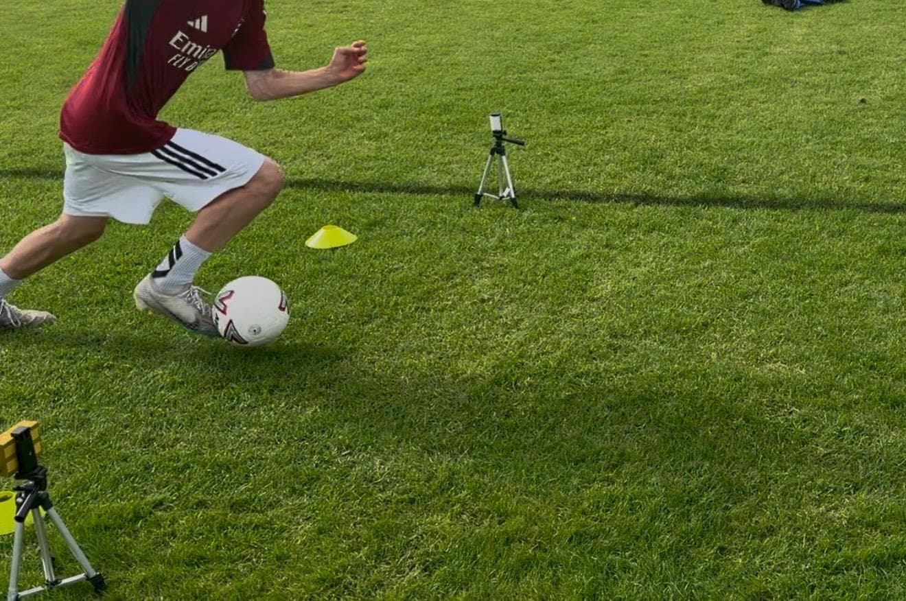 Dribble analysis filming setup — ball-level 240fps camera capturing contact mechanics